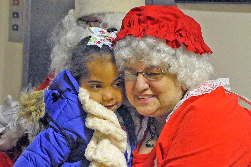 Ayma President, 4, receives a hug from Mrs. Claus after telling Santa what she wanted for Christmas during his visit Saturday, Dec. 3, 2016 to the Moniteau County Courthouse following the annual Christmas parade.