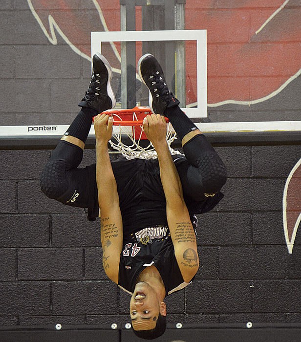 Harlem Ambassador Patric Massey amazes an audience with his upside-down dunk.