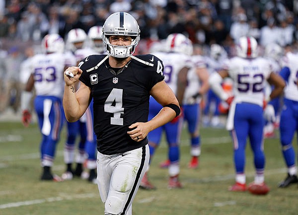Raiders quarterback Derek Carr walks off the field during the second half of Sunday's game against the Bills in Oakland, Calif.