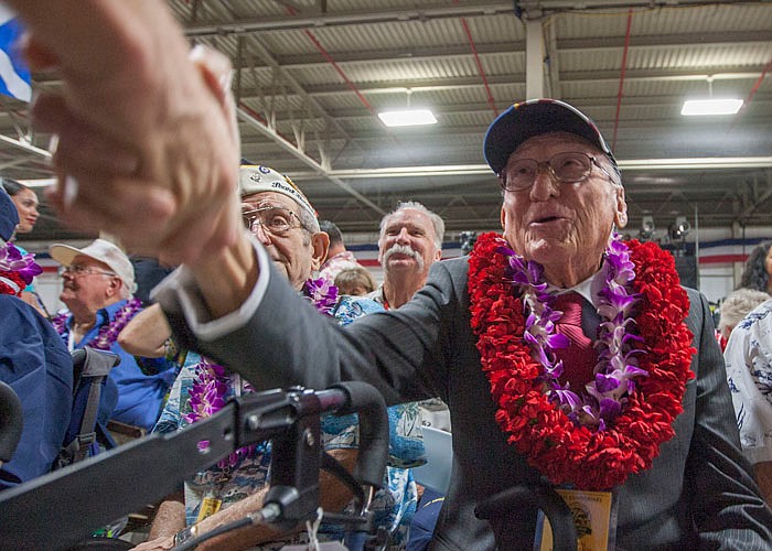 Donald Stratton, center, a USS Arizona survivor, shakes the hand of an admirer Wednesday at Kilo Pier next to the World War II Valor in the Pacific National Monument at Joint Base Pearl Harbor-Hickam, in Honolulu.