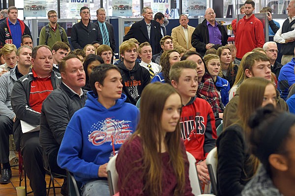 High school basketball coaches and players listen during a press conference Wednesday for the Capital City Shootout, Joe Machens Great 8 Classic and State Farm Holiday Hoops Invitational at Machens Ford.