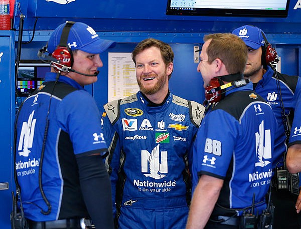 In this June 30 file photo, Dale Earnhardt Jr. (second from left) chats with his crew in the garage during practice at Daytona International Speedway in Daytona Beach, Fla. Earnhardt, who missed the final 18 races of last season because of a concussion, has been medically cleared to return next year. 