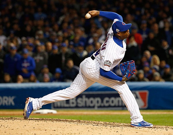 In this Oct. 30 file photo, Cubs relief pitcher Aroldis Chapman throws during the seventh inning of Game 5 of the World Series against the Indians in Chicago. Chapman reached an agreement to return to the Yankees on Wednesday.