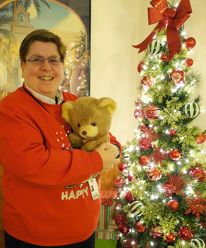 Bonnie Sherer, office assistant with the Callaway County public administrator's office, hugs a teddy bear that will be gifted to a senior citizen. If you have a bear to donate to this effort, call her at 573-642-0720.