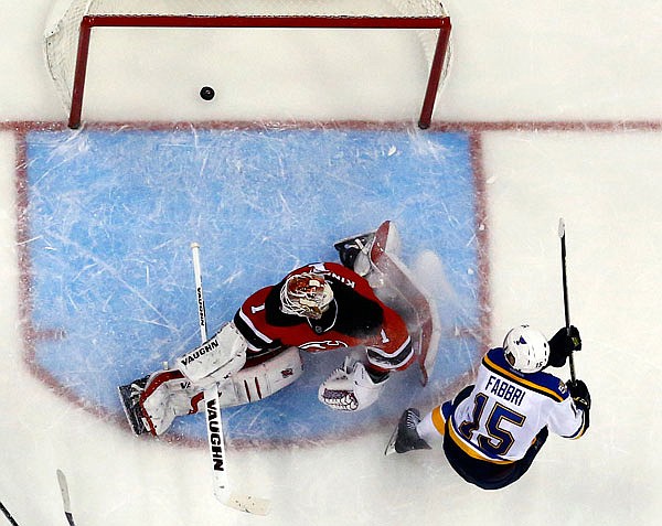 Blues center Robby Fabbri scores a goal on Devils goalie Keith Kinkaid during the third period of Friday's game in Newark, N.J. The Blues won 4-1.