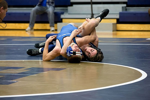 Randy Salaz of Helias tries to get the shoulders of Lutheran's Isaac Conrad on the mat Friday during the Missouri Duals at Helias.