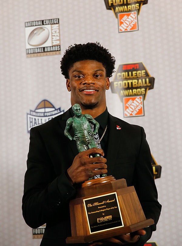 Louisville quarterback Lamar Jackson poses with the Maxwell Award after being named the College Football Player of the Year on Thursday in Atlanta. 