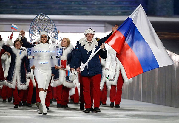 In this Feb. 7, 2014, file photo, Alexander Zubkov of Russia carries the national flag as he leads the team during the opening ceremony of the 2014 Winter Olympics in Sochi, Russia. The Olympic world is bracing for more evidence of systematic Russian doping.