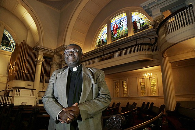 Pastor Abraham Waya poses Tuesday inside the Central United Methodist Church in Brockton, Massachusetts, after announcing the church will become an immigrant sanctuary. Hundreds of houses of worship representing an array of faiths around the country are offering to provide sanctuary for people who could face deportation if President-elect Donald Trump follows through on his campaign pledge.