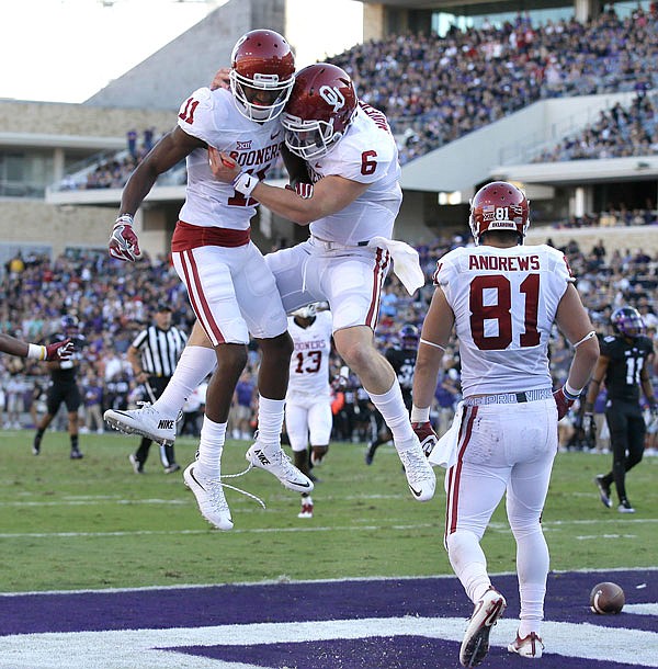 Oklahoma wide receiver Dede Westbrook (left) celebrates catching a touchdown pass with quarterback Baker Mayfield (middle) as wide receiver Mark Andrews (right) looks on during a game earlier this season against TCU in Fort Worth, Texas. Westbrook and Mayfield are finalists for the Heisman Trophy.
