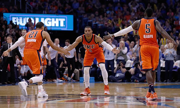 Thunder guard Russell Westbrook (center), guard Andre Roberson (left) and guard Victor Oladipo (right) react after a play against the Magic during a game last month in Oklahoma City. Westbrook is putting up huge numbers, and everybody around him is benefitting.