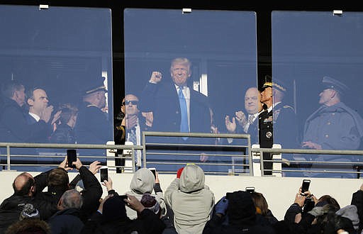 President-elect Donald Trump acknowledges spectators during the first half of the Army-Navy NCAA college football game in Baltimore, Saturday, Dec. 10, 2016. 