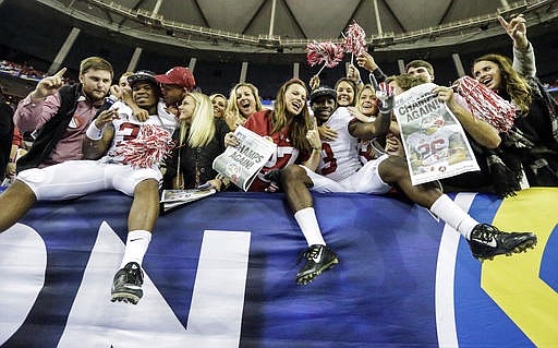 Alabama running back Damien Harris (34) and Alabama wide receiver ArDarius Stewart (13) celebrate with fans during the second half of the Southeastern Conference championship NCAA college football game, Saturday, Dec. 3, 2016, in Atlanta. Alabama won 54-16.