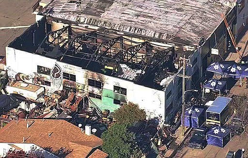This Dec. 3, 2016 file image from video provided by KGO-TV shows the Ghost Ship warehouse after a deadly fire that started late Friday swept through the Oakland, Calif., building. The fire killed dozens of people during a electronic dance party as it raced through the building, in the deadliest structure fire in the U.S. in more than a decade. For those who survived, it was largely a matter of luck that when the first cries of "fire" were heard, they were able to find their way through smoke and darkness or were near enough to a door or already outside.