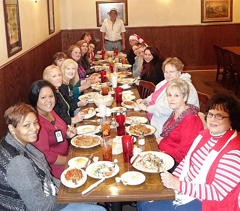 An annual luncheon at Christmas-time brings together the volunteer and professional staff of this area's Texas Child Protective Services. Those pictured here at Luigi's Italian Restaurant in Atlanta, Texas, participated in sorting and wrapping Christmas presents for 120 children in CPS care.