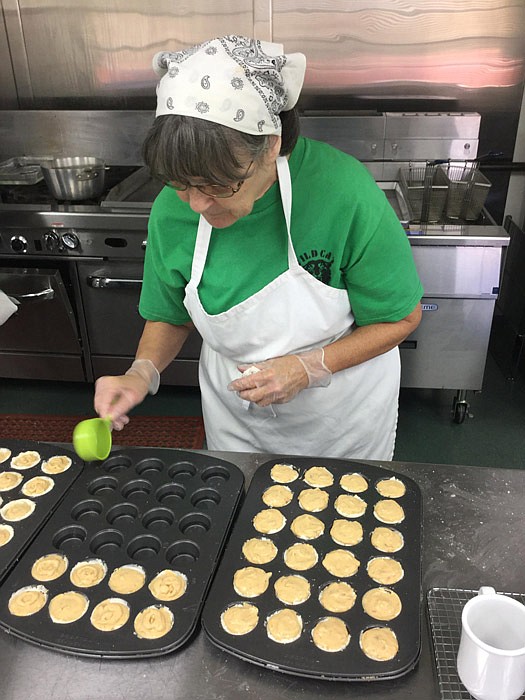 Volunteer Winnie McKinley helps prepare mini cheesecakes at the Nov. 5 Dining Wild event.