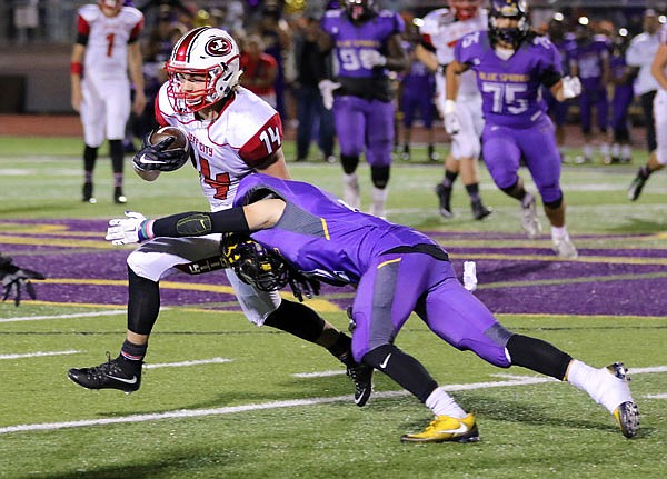 Jefferson City wide receiver Adam Huff breaks a tackle during a district semifinal game earlier this season at Blue Springs. Huff was named a Missouri Media first team all-state player.