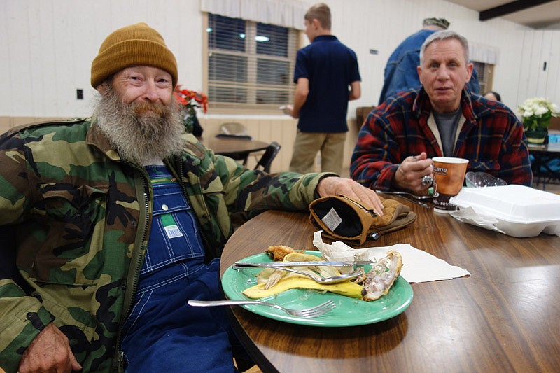 Gene Johnson, left, and Bill Bond finish a hearty meal at the Holts Summit Soup Kitchen.