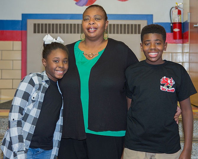 Benita Stennis, center, is pictured with her two children, Kendall and Keith, who participate in programs at the Boys & Girls Club, which Benita said helps her balance her evening work meetings while knowing her children are safe. 