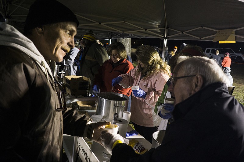 Participants in the third annual Bridge City Project chili cook-off fill cups of chili on Jan. 22, 2016. 