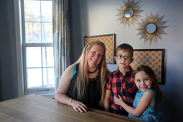 Erin Kremer, left, became a mother eight years ago when she opened her home to the first of more than 20 children through the state foster care program — Joseph, center, and Emma Anne eventually were adopted.