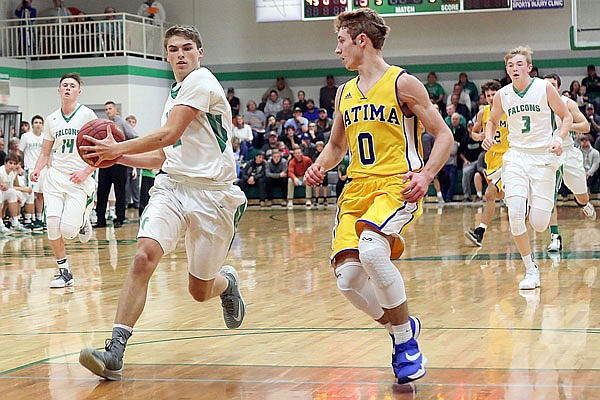 Blair Oaks senior Dylan Skinner (left) drives to the basket against Fatima junior Sam Groner during the first half of Thursday night's game at Wardsville.