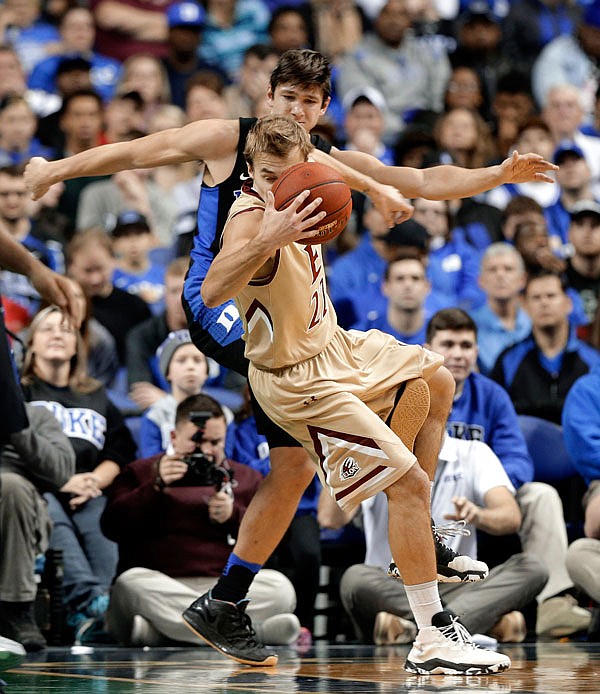 Elon's Steven Santa Ana (foreground) is tripped by Duke's Grayson Allen during Wednesday's game in Greensboro, N.C. Allen was called for a technical foul on the play.