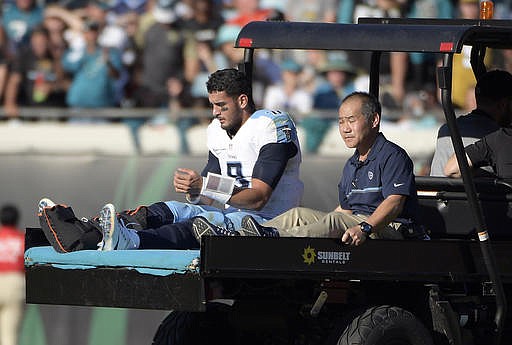 Tennessee Titans quarterback Marcus Mariota leaves the field on a cart after he was injured during the second half of an NFL football game against the Jacksonville Jaguars, Saturday, Dec. 24, 2016, in Jacksonville, Fla. (AP Photo/Phelan M. Ebenhack)