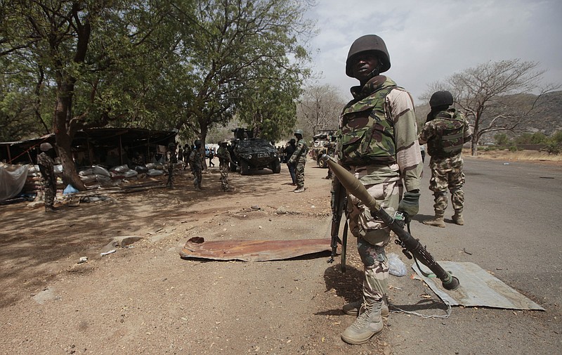 In this Wednesday April 8, 2015 file photo, Nigerian soldiers man a checkpoint in Gwoza, Nigeria. The Boko Haram extremist group has finally been crushed — driven from its last forest enclave with fighters on the run and no place to hide, Nigeria's president declared Saturday, Dec. 24, 2016.