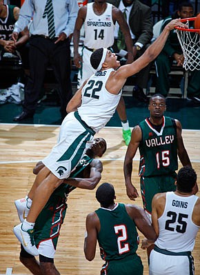 In this Nov. 18 file photo, Michigan State's Miles Bridges dunks over Mississippi Valley State's Jamal Watson during a game in East Lansing, Mich.