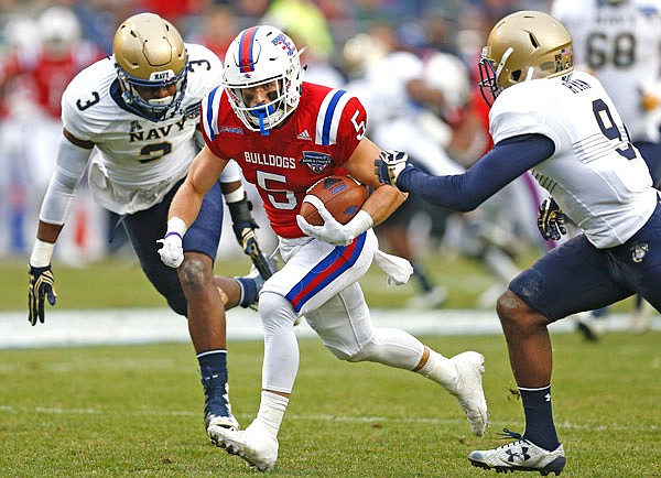 Louisiana Tech wide receiver Trent Taylor (center) runs for a touchdown after a catch past Navy cornerback Jarid Ryan (right) and linebacker Brandon Jones during first half of Friday's Armed Forces Bowl in Fort Worth, Texas.