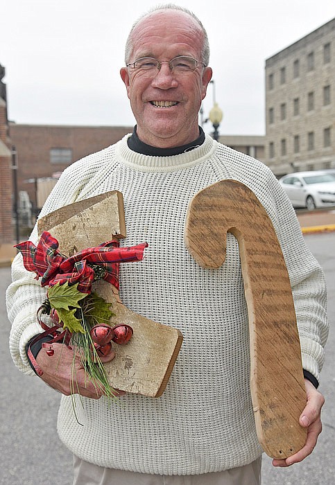 Eddie Mulholland holds his handmade, wooden Christmas stocking. He is the principal for St. Martin School in St. Martins, Mo.