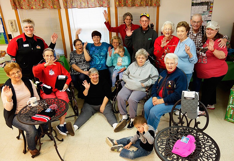 Residents at the North Callaway Senior Center received gifts from the community, including new lawn furniture,
as a Friday morning surprise. The holiday endeavor started with employees at Casey's General Store in
Auxvasse, Mo., said the store's general manager Bobbie Wallace, standing in the upper left, and then spread to
everyone in town.