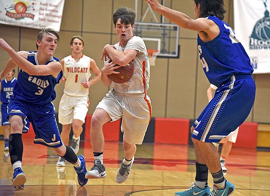 Nick Hammann of New Bloomfield grabs the ball during Tuesday's game against Jamestown in the Capital City Shootout at Fleming Fieldhouse.