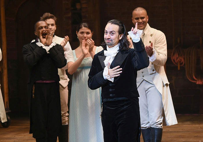 "Hamilton" creator Lin-Manuel Miranda, foreground, gestures in July during his final performance curtain call in New York. 