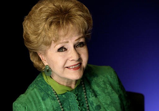 This Oct. 14, 2011 file photo shows actress Debbie Reynolds posing for a portrait in New York. Reynolds, star of the 1952 classic "Singin' in the Rain" died Wednesday, Dec. 28, 2016, according to her son Todd Fisher. She was 84. 