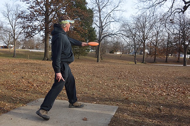 Joe Duncan, a regular disc golfer in Fulton, plays a hole at the Veterans Park disc golf course. The New Year's Day tournament will take place at the Greenway Park in Holts Summit.