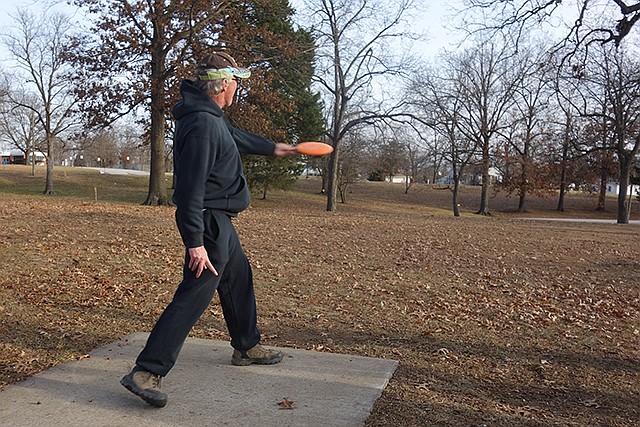 Joe Douglas, a regular disc golfer in Fulton, plays a hole at the Veterans Park disc golf course. The New Year's Day tournament will take place at the Greenway Park in Holts Summit.