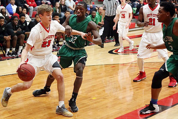 Ben Folz of Jefferson City tries to get past Dajour Cameron of Western (Ky.) during Wednesday night's game in the Joe Machens Great 8 Classic at Fleming Fieldhouse.