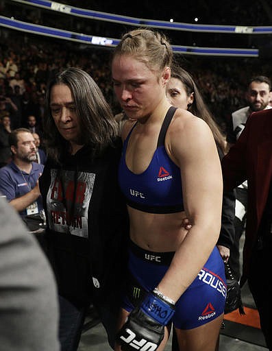 Ronda Rousey leaves the octagon after losing to Amanda Nunes in the first round of their women's bantamweight championship mixed martial arts bout at UFC 207, Friday, Dec. 30, 2016, in Las Vegas. Nunes won the fight after it was stopped in the first round.