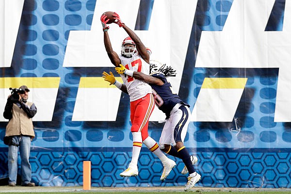 Chiefs wide receiver Chris Conley grabs a pass as Chargers cornerback Trovon Reed defends during the second half of Sunday's game in San Diego.