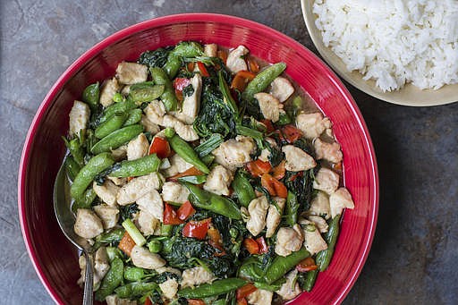 This November 2016 photo shows chicken and vegetable stir fry in New York. This dish is from a recipe by Katie Workman. 