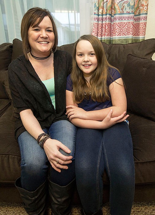 Lung transplant recipient, Caryn Durbin, sits with her daughter, Bailey Artinger, 10, during a family Christmas celebration Dec. 22 in her home in Joplin.