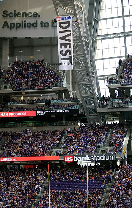 Protesters against the Dakota Access Pipeline rappel from the catwalk in U.S. Bank Stadium during the first half of an NFL game between the Minnesota Vikings and the Chicago Bears Sunday in Minneapolis.