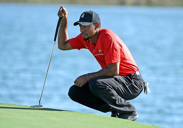 In this Dec. 4, 2016, file photo, Tiger Woods lines up a putt on the 17th hole during the final round of the Hero World Challenge in Nassau, Bahamas.