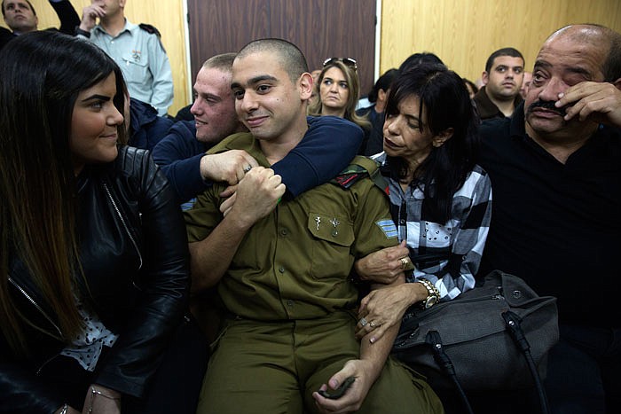 Israeli solider Sgt. Elor Azaria waits with his parents for the verdict inside the military court in Tel Aviv, Israel, on Wednesday.