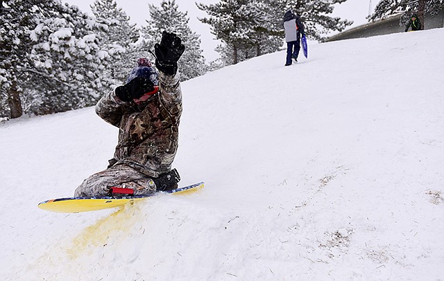 Giorgio Spensieri, 12, sleds Thursday in Longmont, Colorado. Connor's injured paw was wrapped up to keep it from getting wet. Forecasters predict the fast-moving storm will move out of the region and take aim at the southeast by the weekend ahead.