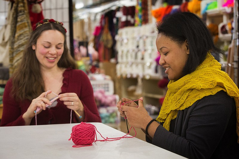 Jennifer Miller, left, a yarn wrangler, and Jessica Owens, manager of Weaving Works in Seattle, Wash., get started on knitting Pussyhats for women to wear at the Women's March on Washington. 