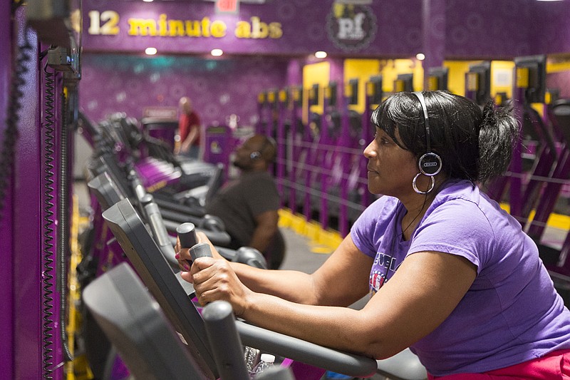 Temika Dolberry works out Friday at Planet Fitness. Dolberry likes Planet Fitness because of the low-pressure environment and the 24-hour facility accommodates her family's schedule.