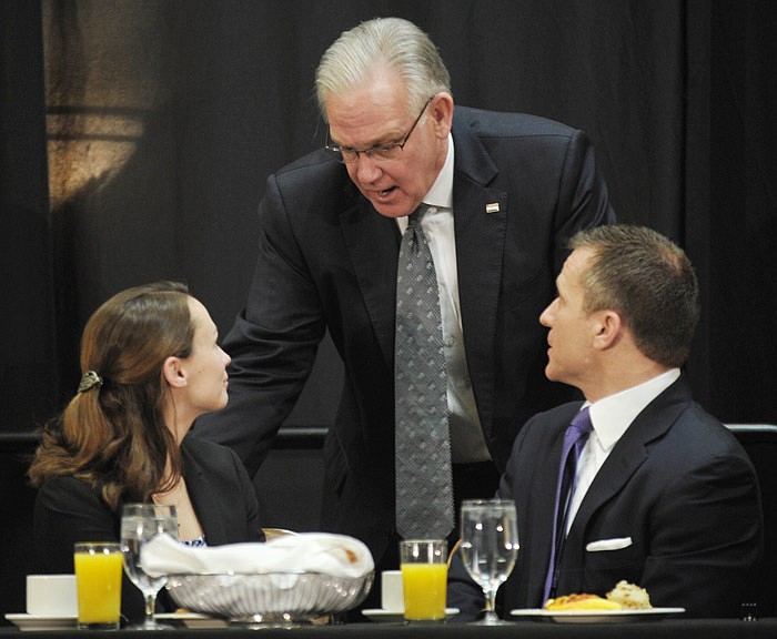 Missouri Gov. Jay Nixon, middle, visits with Sheena Greitens and Gov.-elect Eric Greitens at the Governor's Prayer Breakfast on Jan. 5, 2017. It was Greiten's first and Nixon's eighth and final time as governor at the annual event.